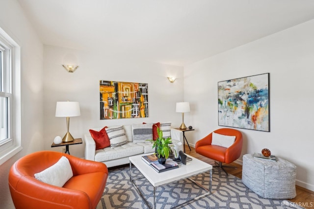 living area featuring baseboards and wood finished floors