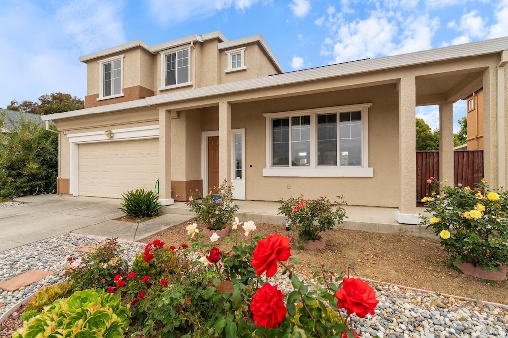 view of front of home featuring covered porch and a garage