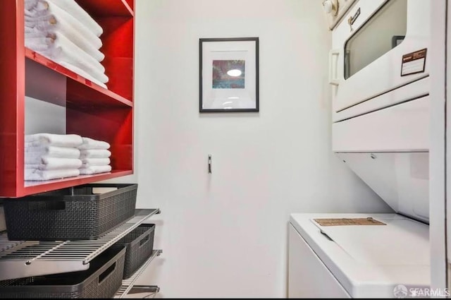 laundry area featuring stacked washing maching and dryer