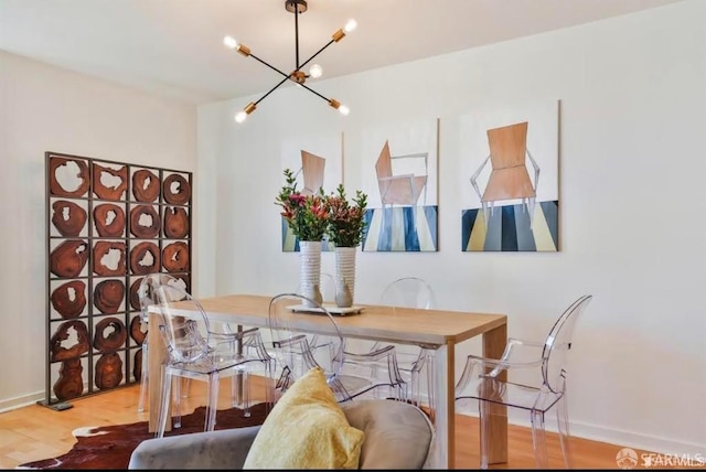 dining room with hardwood / wood-style flooring and an inviting chandelier