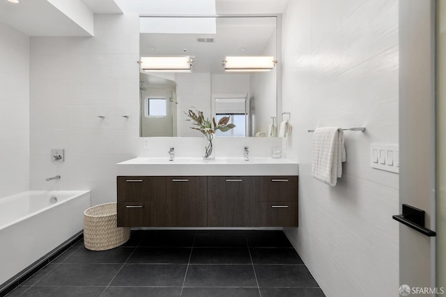 bathroom featuring vanity, tile patterned floors, and tile walls