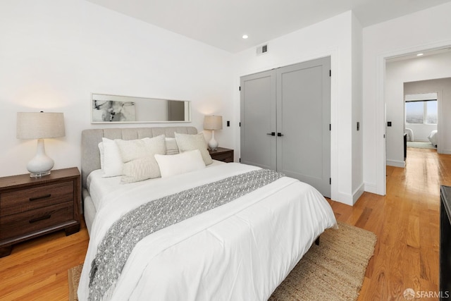 bedroom featuring light hardwood / wood-style flooring and a closet