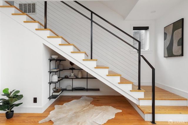 stairway with hardwood / wood-style floors