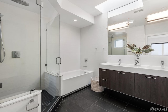 full bathroom with plus walk in shower, vanity, tile patterned floors, and a healthy amount of sunlight