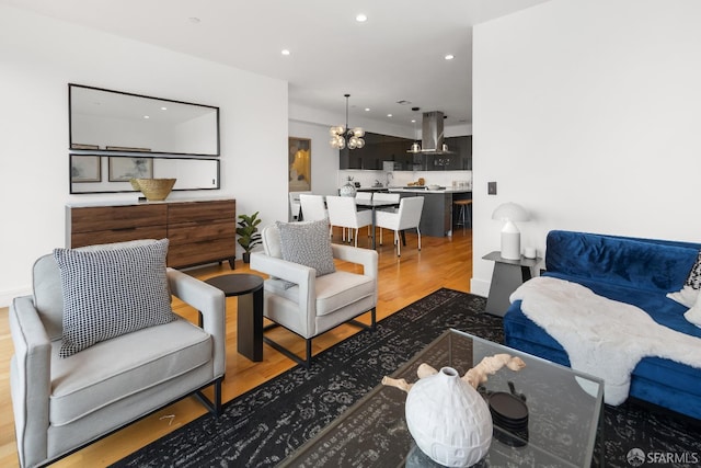 living room featuring wood-type flooring and a chandelier