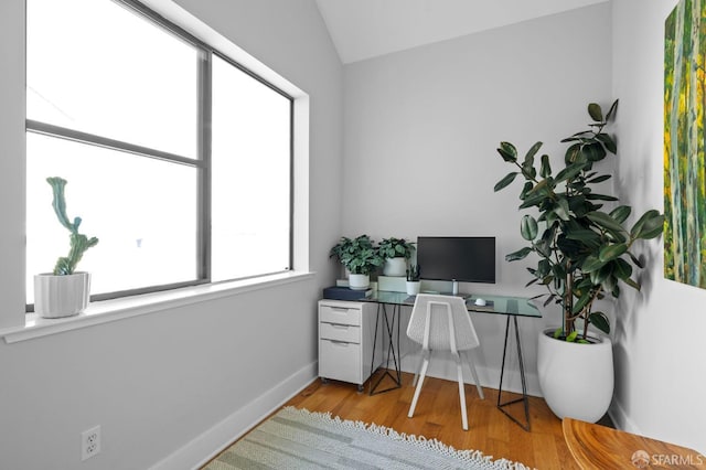 office space with light hardwood / wood-style flooring and vaulted ceiling