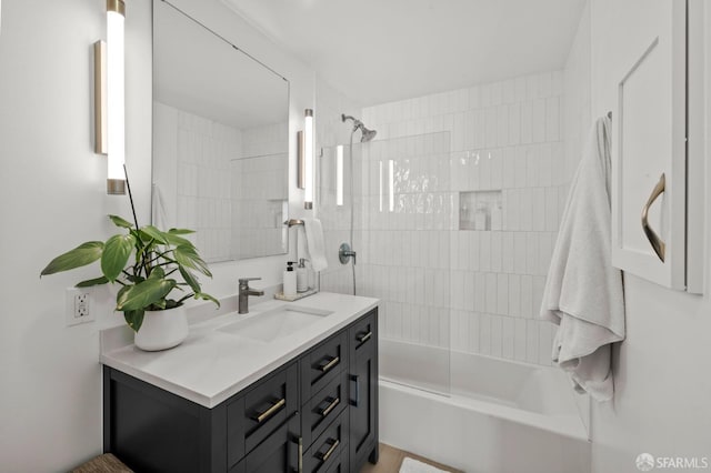 bathroom featuring vanity and tiled shower / bath combo