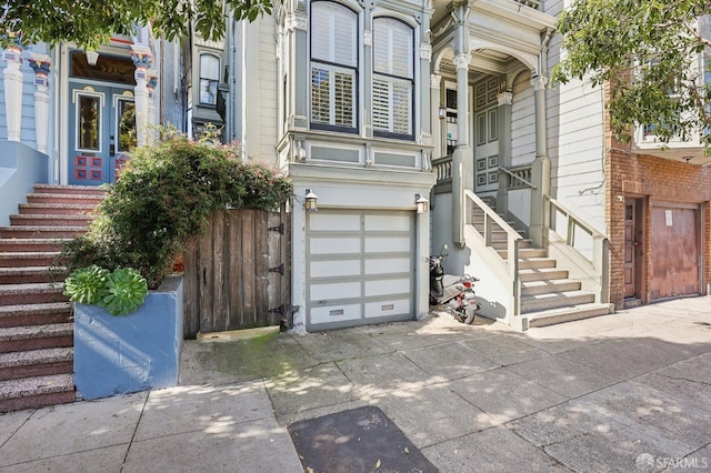 doorway to property featuring driveway and an attached garage