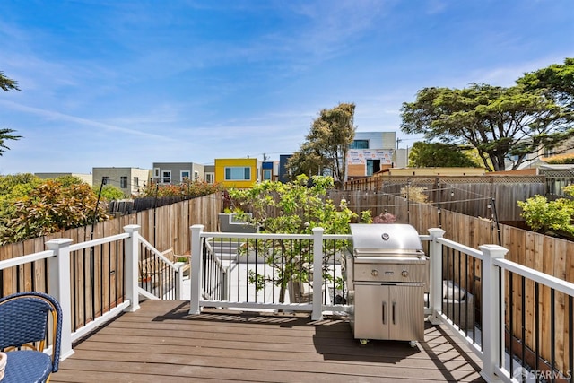 deck featuring grilling area and fence