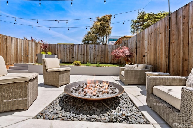view of patio featuring an outdoor living space with a fire pit and a fenced backyard