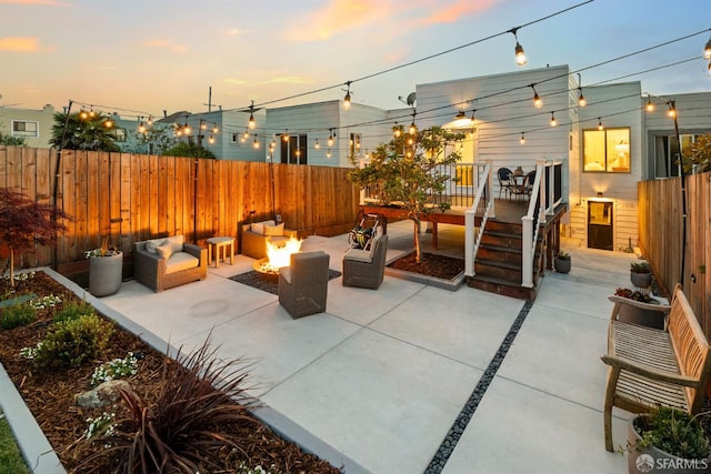 view of patio / terrace featuring fence, an outdoor living space with a fire pit, and a deck