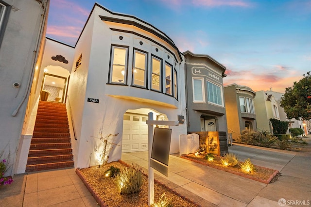view of front facade featuring stucco siding and a garage