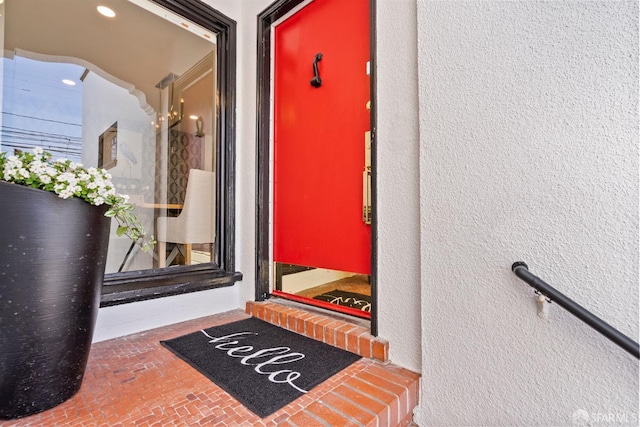 view of exterior entry featuring stucco siding
