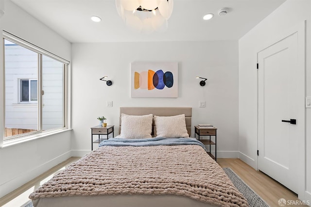 bedroom featuring light wood-type flooring, baseboards, and recessed lighting
