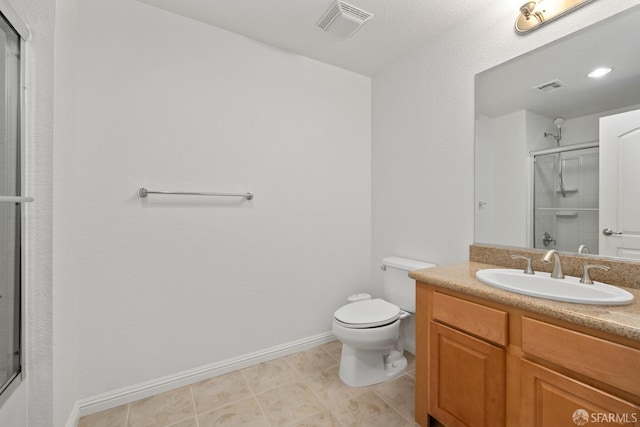 bathroom featuring vanity, an enclosed shower, tile patterned floors, and toilet