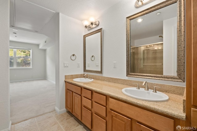 bathroom with tile patterned flooring, vanity, and a shower with shower door