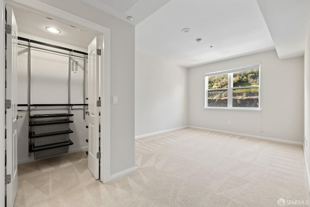 unfurnished bedroom featuring light carpet