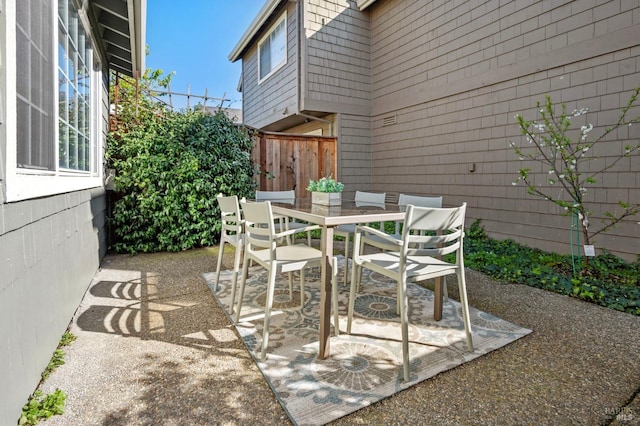 view of patio / terrace with outdoor dining area and fence