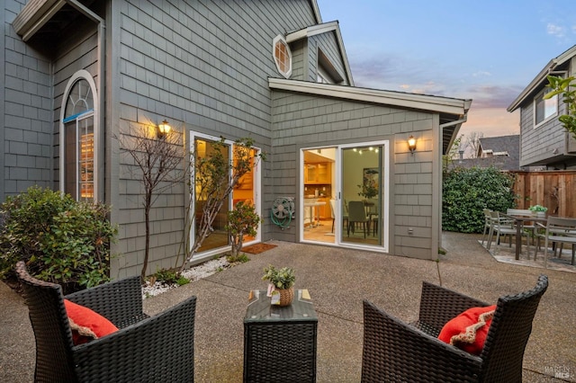 exterior space featuring outdoor dining area, a patio area, and fence