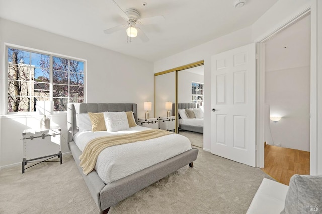 carpeted bedroom with a ceiling fan and a closet