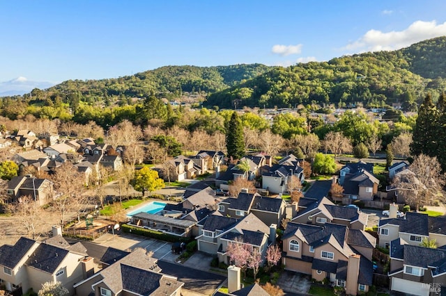 bird's eye view with a wooded view and a residential view