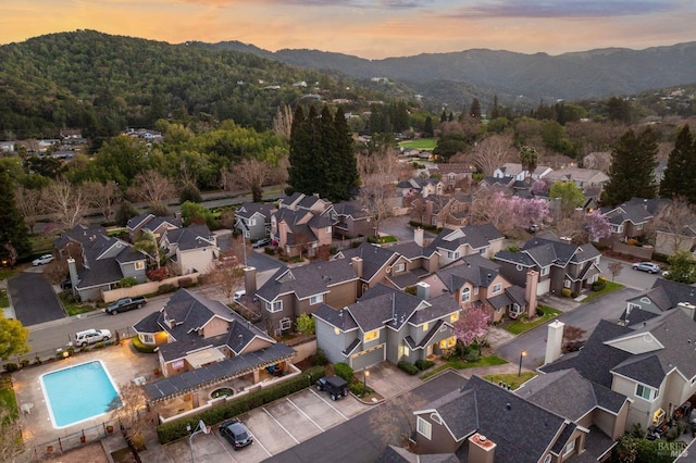 aerial view at dusk featuring a residential view and a mountain view