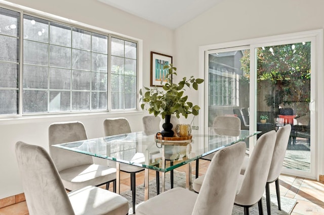 dining room featuring vaulted ceiling