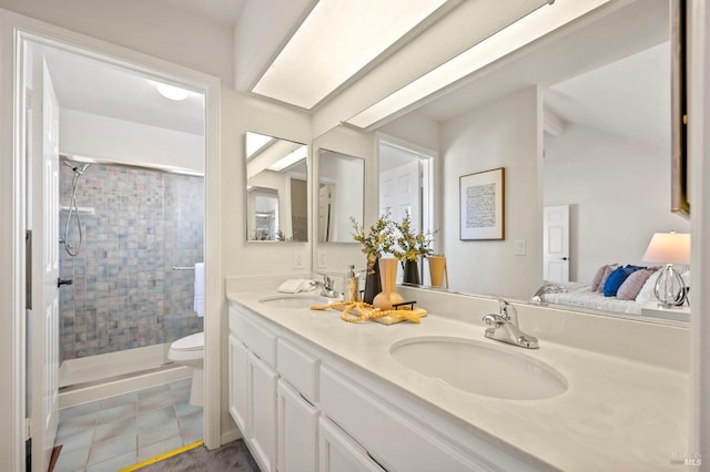 full bathroom featuring double vanity, a stall shower, and a sink