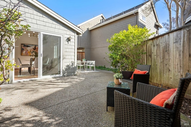 view of patio / terrace featuring outdoor dining area and fence