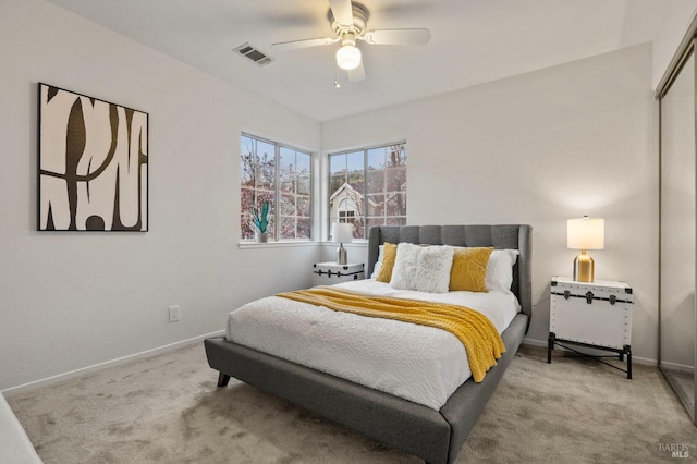 bedroom with a closet, visible vents, carpet flooring, ceiling fan, and baseboards