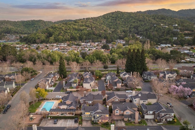 aerial view at dusk featuring a residential view and a mountain view