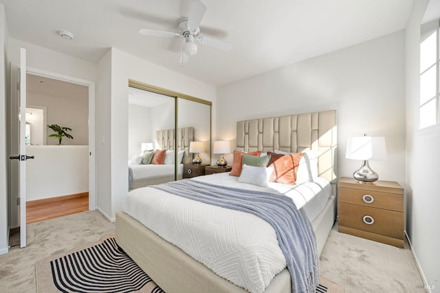 bedroom with ceiling fan, a closet, carpet flooring, and baseboards