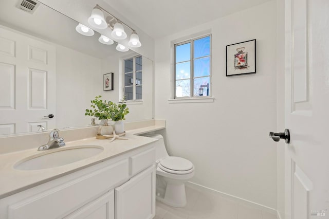 bathroom featuring tile patterned flooring, toilet, vanity, visible vents, and baseboards