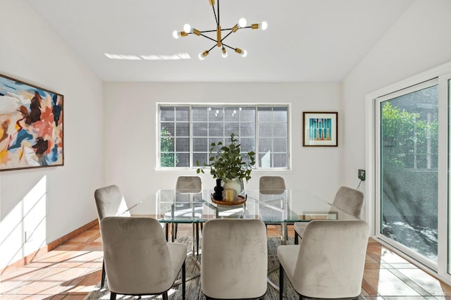 dining room with baseboards, a chandelier, a wealth of natural light, and light tile patterned flooring