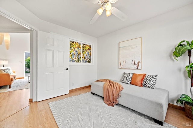 sitting room with light wood-type flooring, ceiling fan, and baseboards