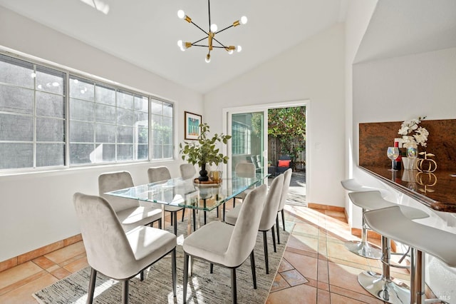 dining room featuring lofted ceiling, light tile patterned flooring, baseboards, and a notable chandelier