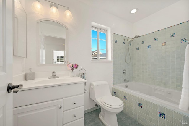 full bath featuring tiled shower / bath combo, vanity, toilet, and tile patterned floors