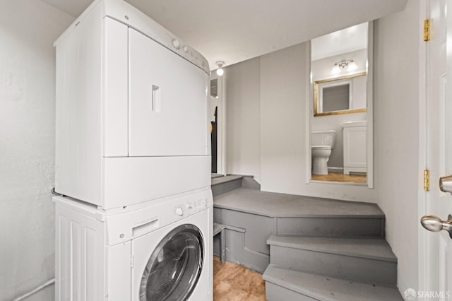 laundry area featuring stacked washer and dryer and laundry area