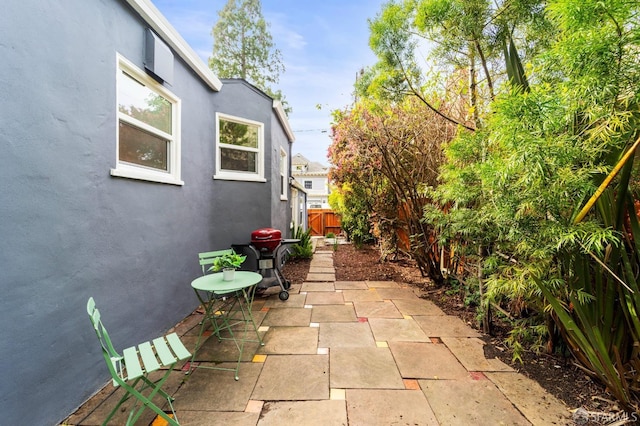 view of patio featuring fence