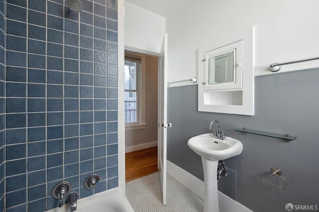 bathroom featuring tiled shower / bath combo and tile patterned floors