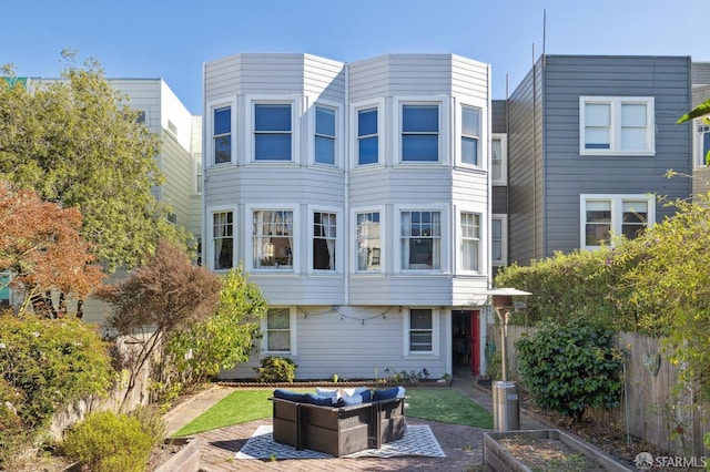 view of front of home featuring an outdoor living space and a patio area