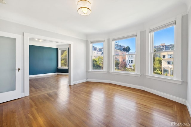 unfurnished room featuring hardwood / wood-style floors