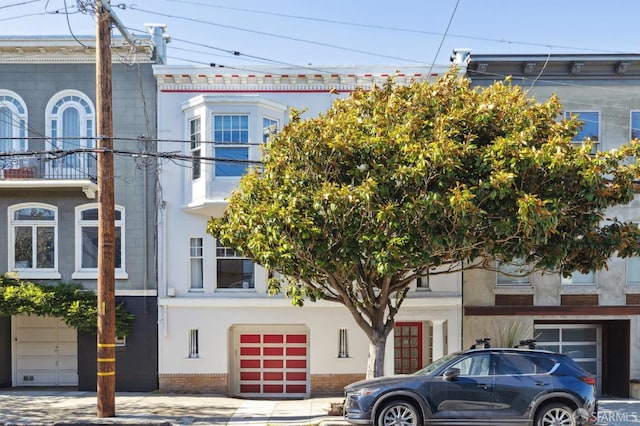 view of front of house with a balcony and a garage