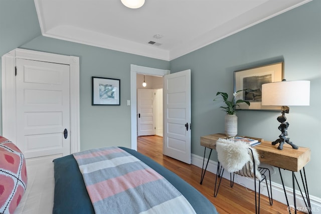 bedroom featuring lofted ceiling and wood-type flooring