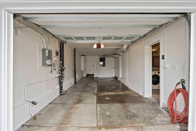 garage with a garage door opener and washer / dryer