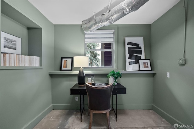 office area with concrete flooring