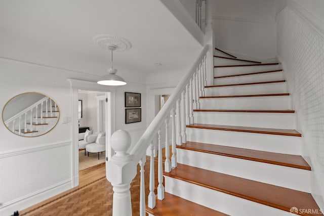 stairs featuring parquet floors