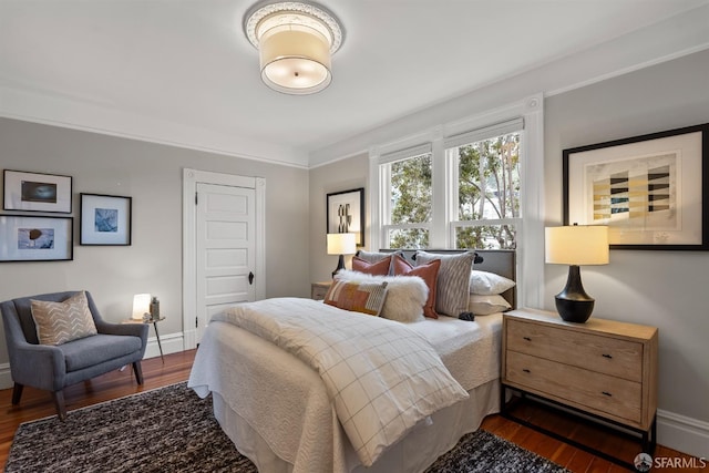 bedroom with dark hardwood / wood-style flooring