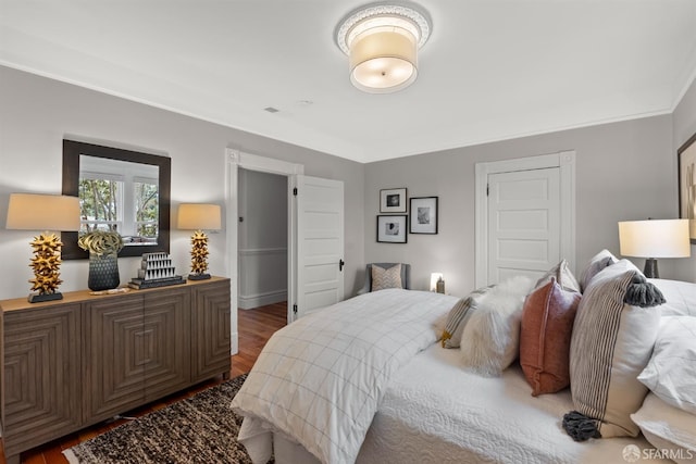 bedroom with dark hardwood / wood-style flooring