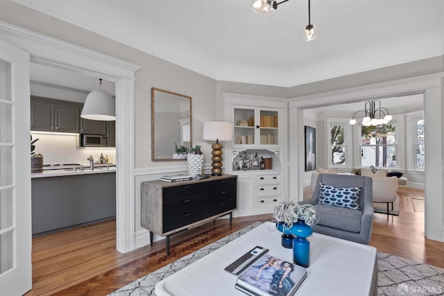 living room featuring parquet flooring and an inviting chandelier